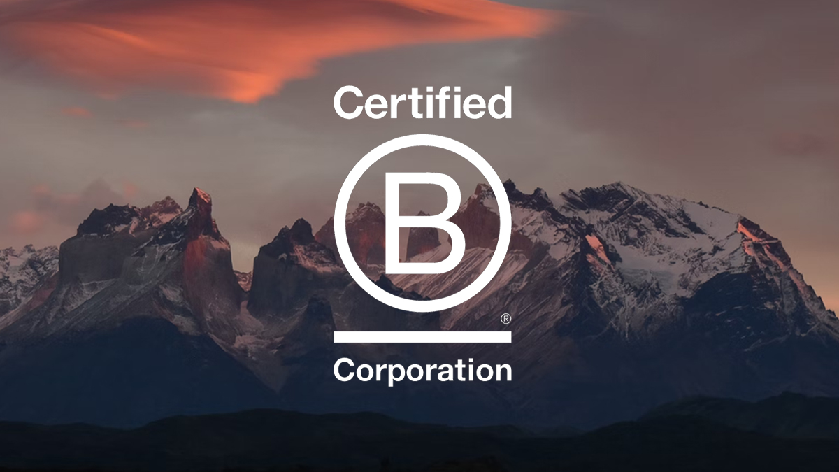 Mountain peak at sunset with B Corporation logo